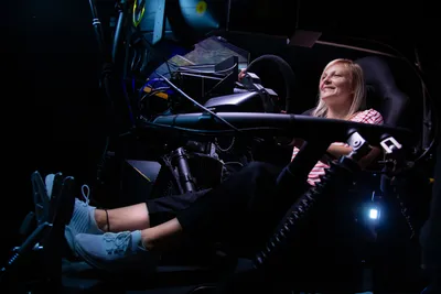 A woman inside a racing simulator