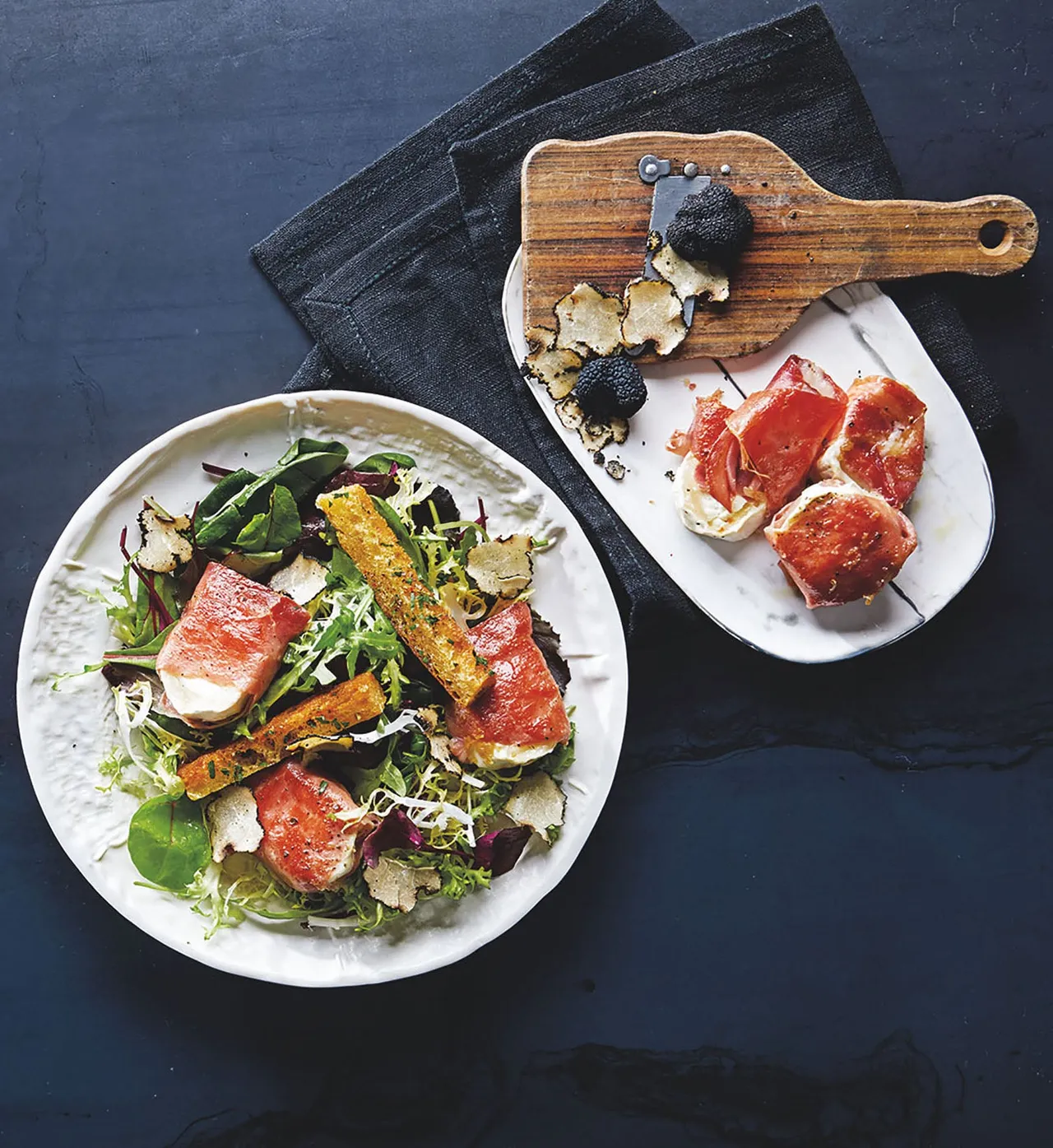 Mixed green salad with prosciutto-wrapped goat cheese, croutons and shaved black truffle