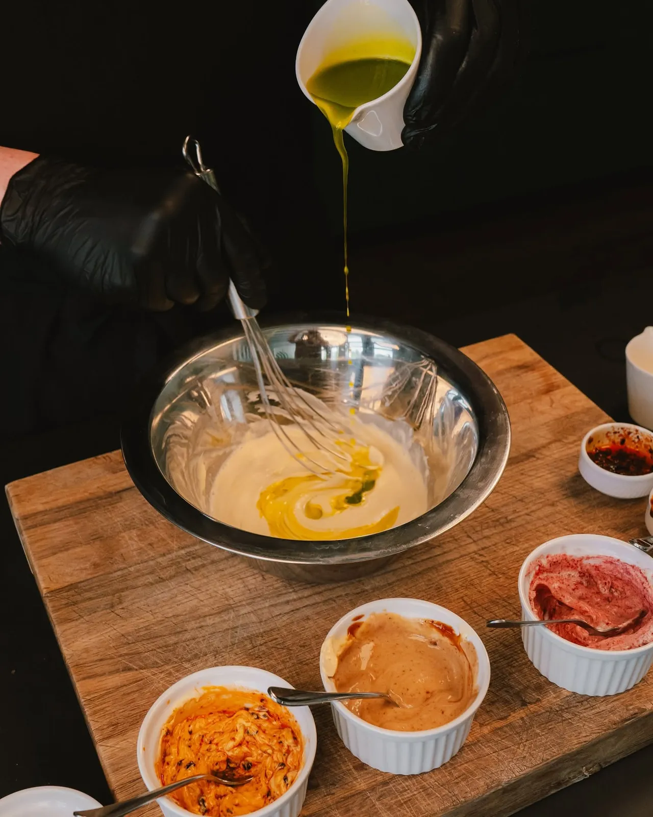 Whisking a sauce in a steel bowl