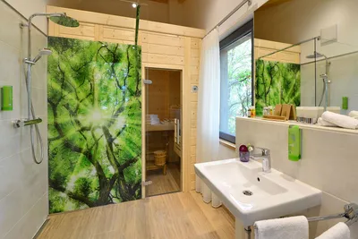 Modern tree chalet bathroom with rain shower, washbasin and private sauna