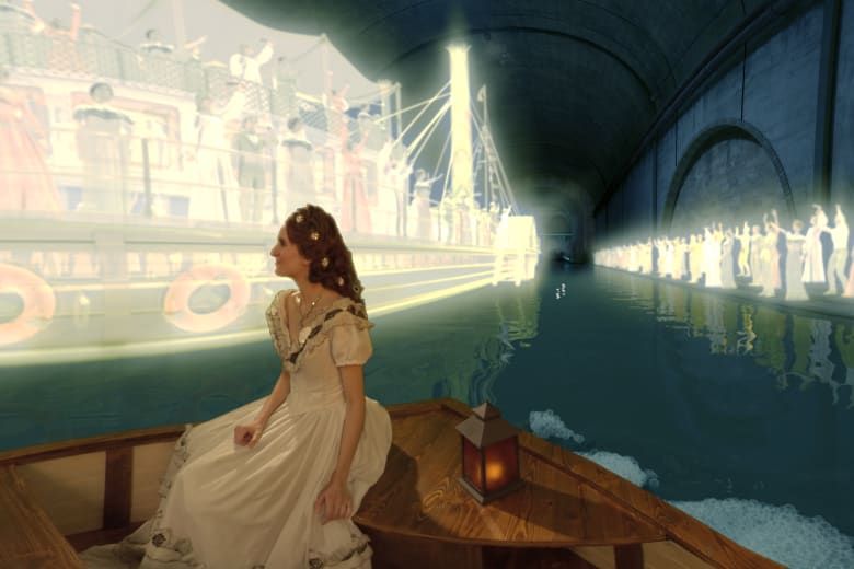 Woman in period costume as Empress Elisabeth (Sisi) sitting in a boat, gazing at an illuminated bridge scene with a cheering crowd.