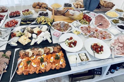 Buffet with smoked salmon, cheese platter, cold cuts and mozzarella-tomato skewers