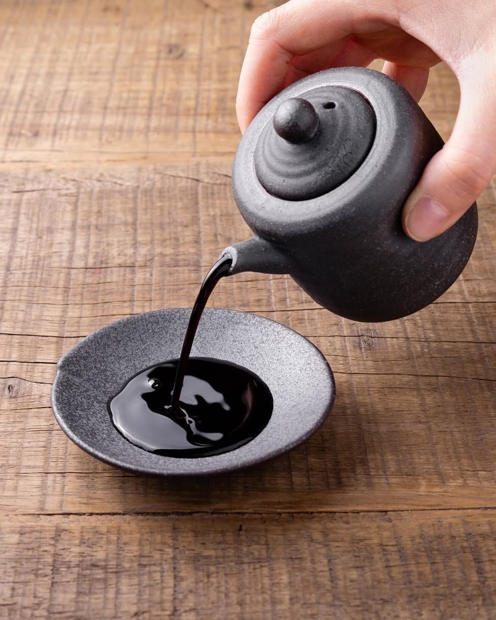 Soy sauce being poured on a plate