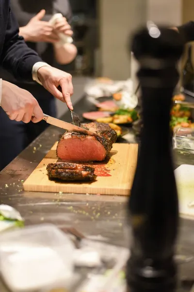 A person cutting meat