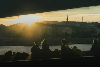 Boat tours: guests on a boat on the river at sunset with the city skyline