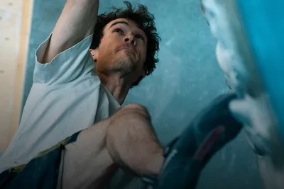 Climbing & bouldering: climber reaching for a hold on a bouldering wall