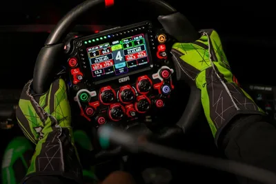 Racing simulator: gloved hands on a sim racing steering wheel