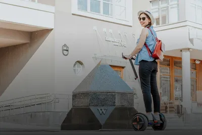 Segway tour: smiling woman on a Segway in front of a historic building