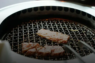 BBQ course: meat sizzling on a grill