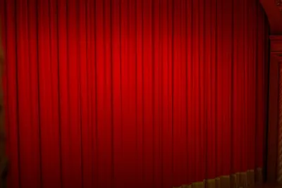 Dinner show: red theatre curtain on stage