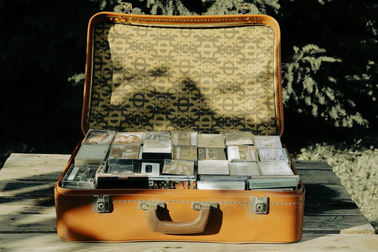 Open vintage suitcase packed with bundles of banknotes