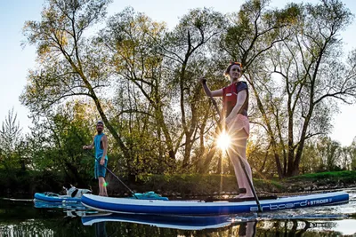 Two people on a SUP at setting sun