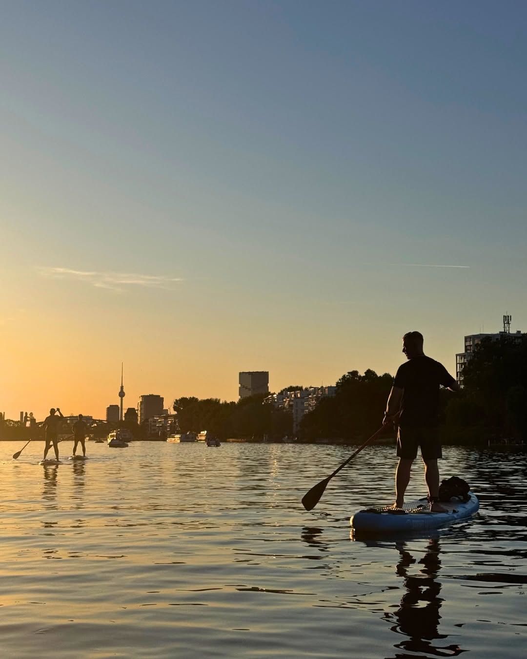 A group of people on SUPs during sunset