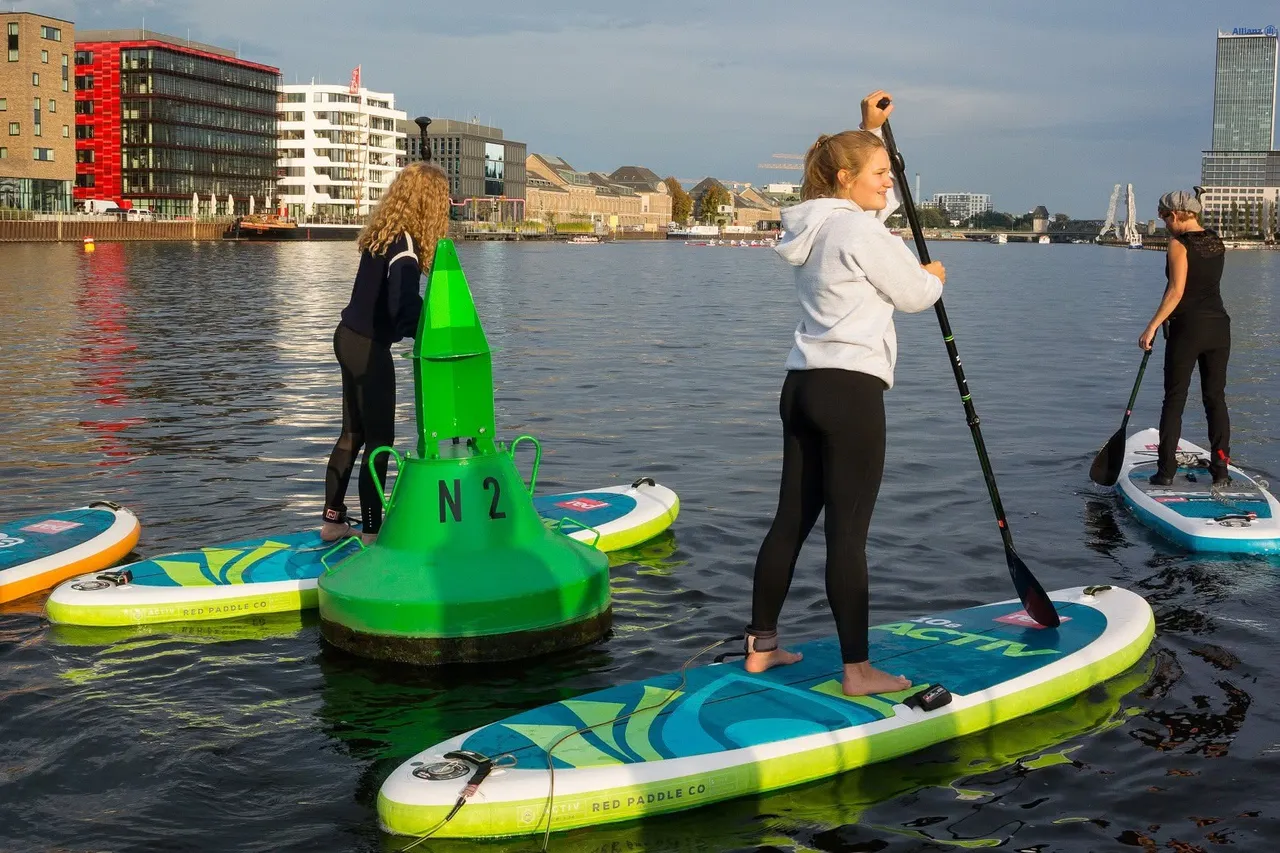 A group of people on SUP boards on the river Spree in Berlin