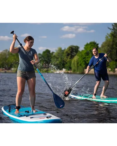 Two people having fun on a SUP board on a river