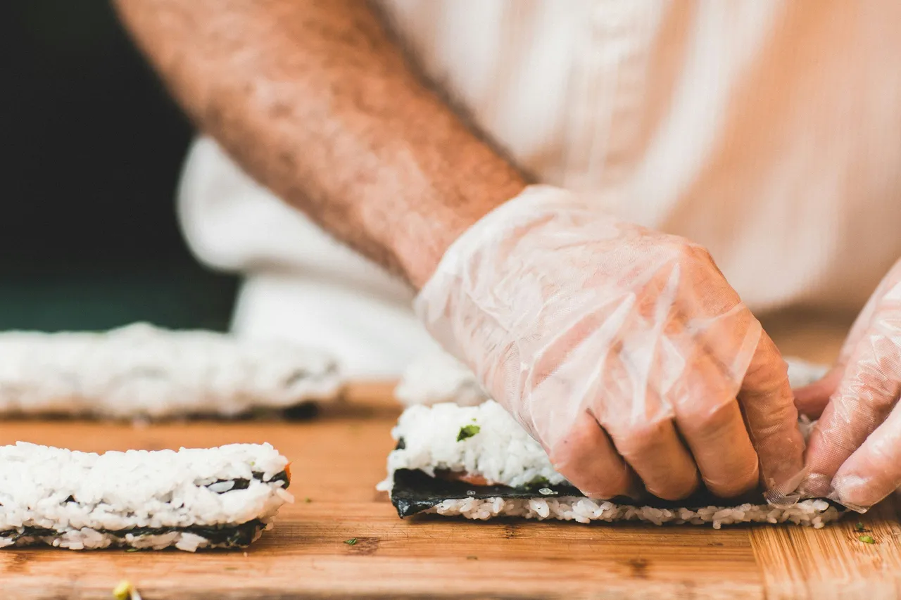 A person preparing sushi