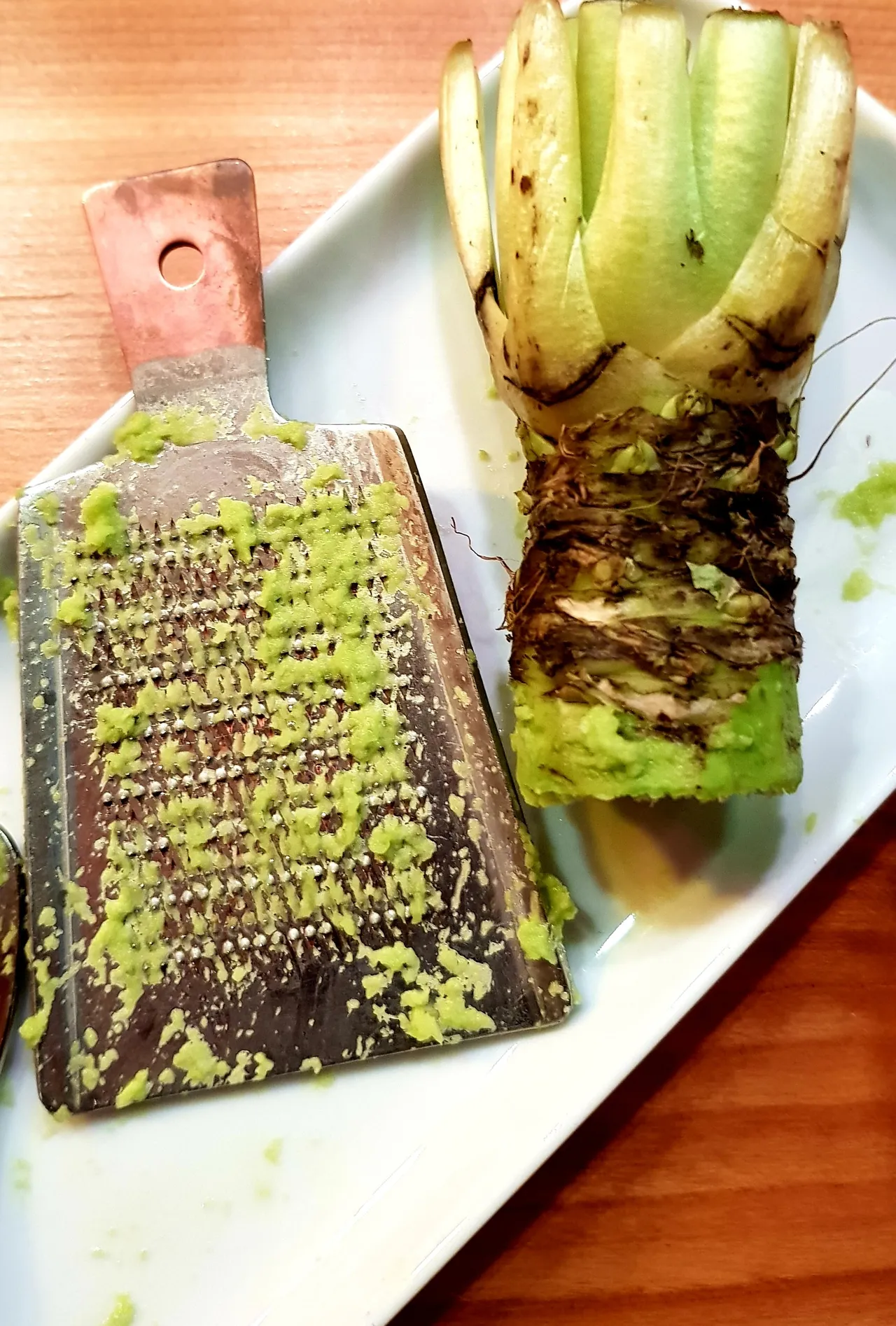 Fresh wasabi root and sushi ingredients on a table