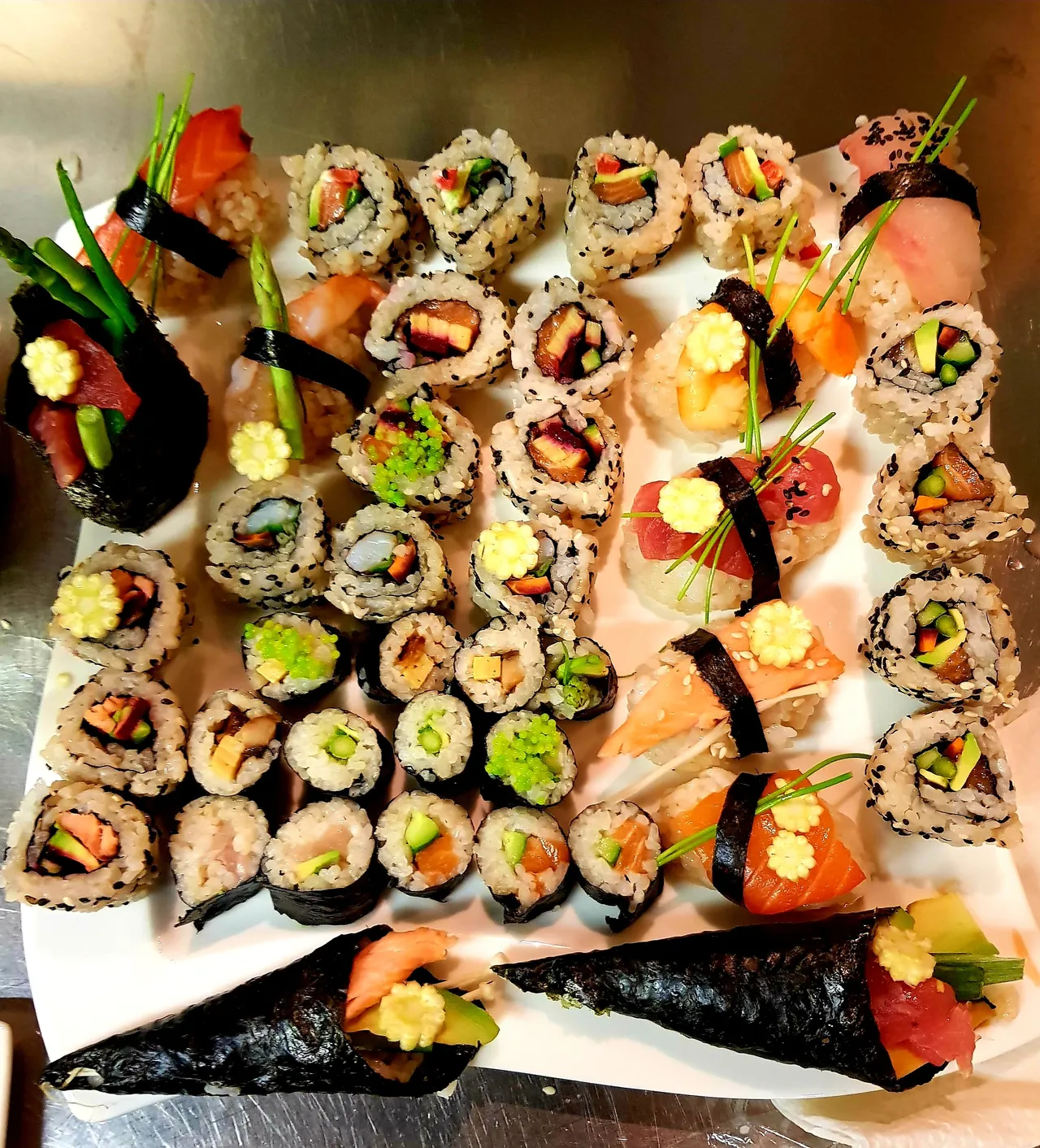 Many pieces of sushi served on a plate