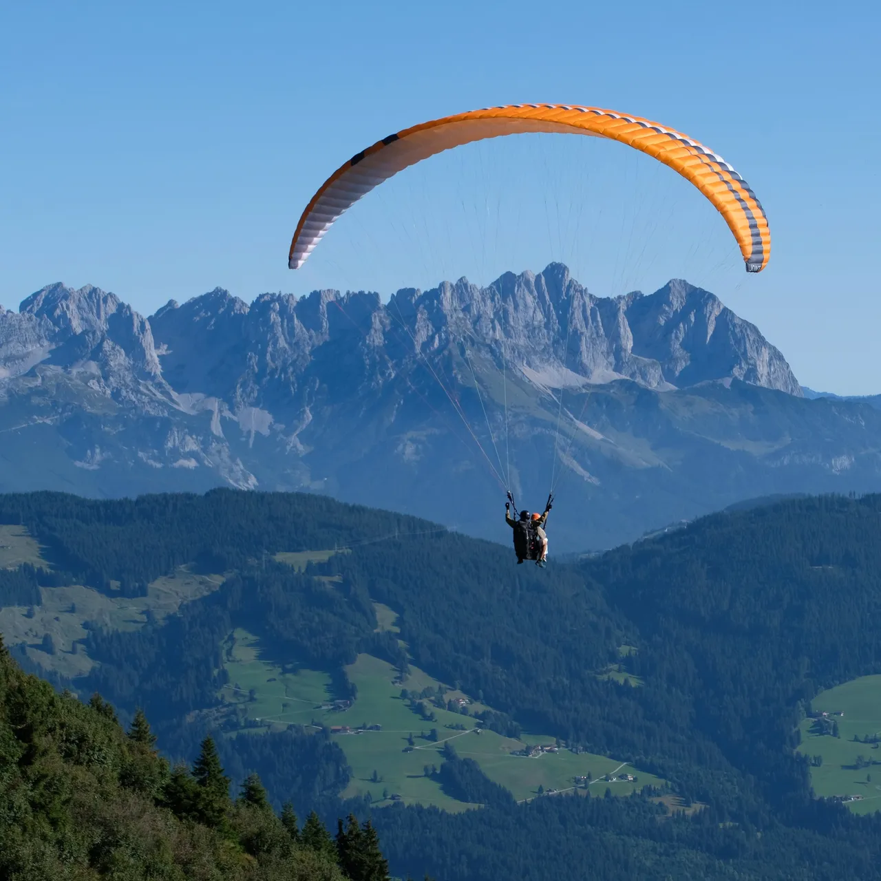 Paraglider over mountain landscape
