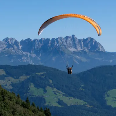 Paraglider over mountain landscape
