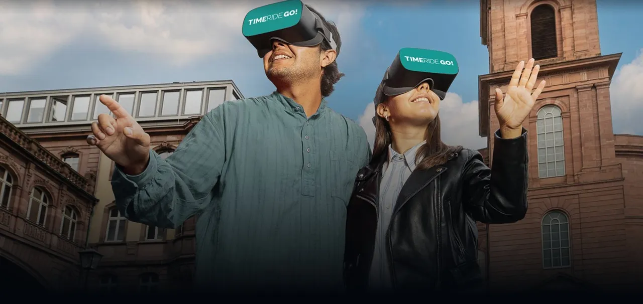 Man and woman wearing TimeRide GO! virtual reality headsets, pointing and smiling while exploring a historic European city square