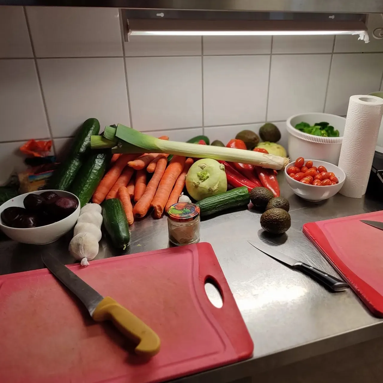 Various vegetables, cutting board and knife on a table