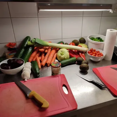 Various vegetables, cutting board and knife on a table