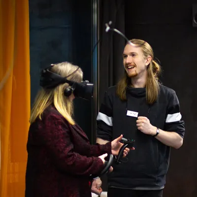 Two people playing a virtual game with VR glasses