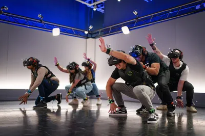 A group of people dancing while wearing VR glasses