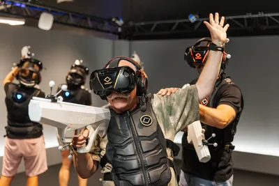 A group of people playing a virtual adventure with guns