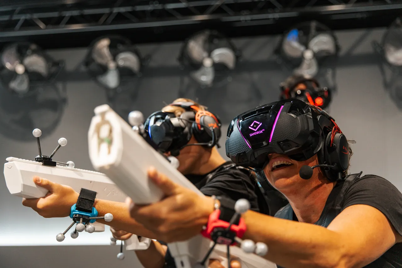 A group of people playing a virtual adventure with guns