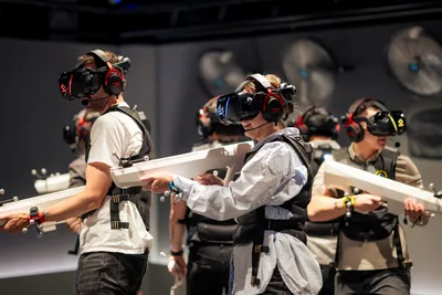A group of people playing a virtual adventure with guns