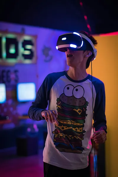 A boy looking stunned through VR glasses