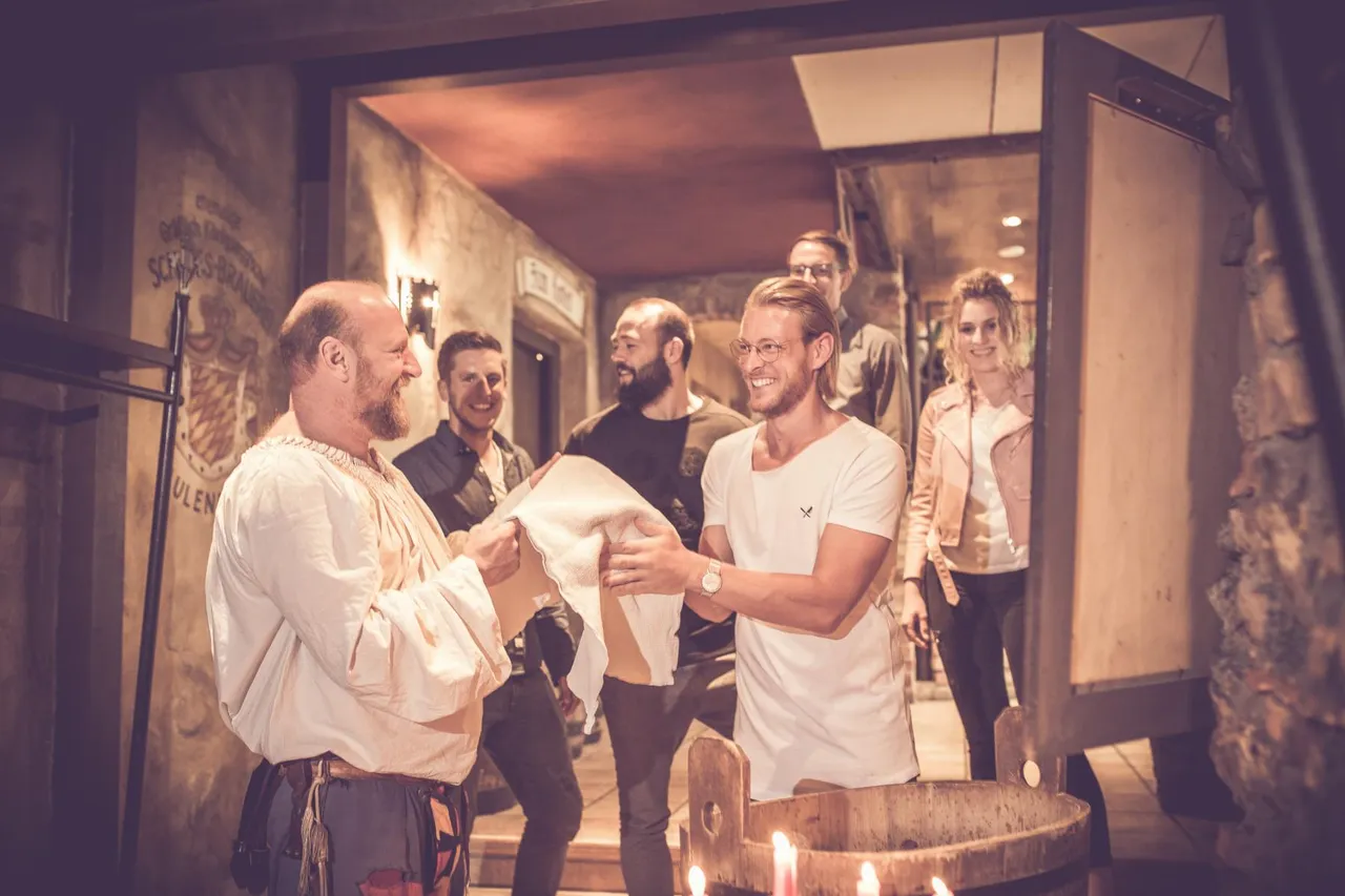 Guests at the welcome hand-washing ritual with the cupbearer