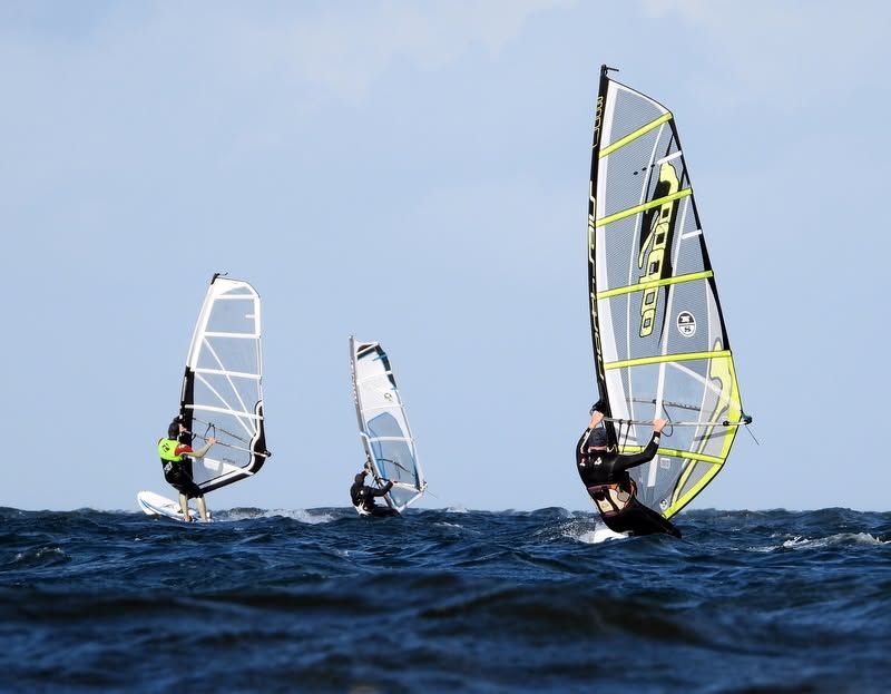 The people windsurfing on the water