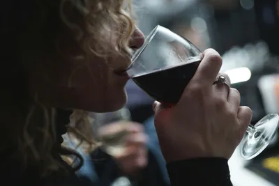 Woman sipping red wine from a glass