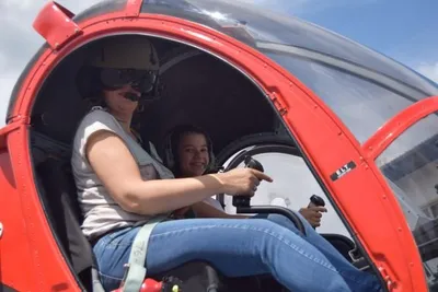 A woman and a child sitting in a helicopter
